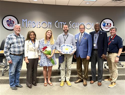 Tim Holtcamp and wife Misty with Board at meeting